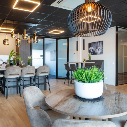 Stijlvol ingerichte kantoorruimte met houten vloeren, moderne verlichting en verschillende zitgelegenheden op Kapitein Rondairestraat 8 in Tilburg. Mogelijkheid om dit kantoorpand te huren voor een inspirerende werkomgeving.