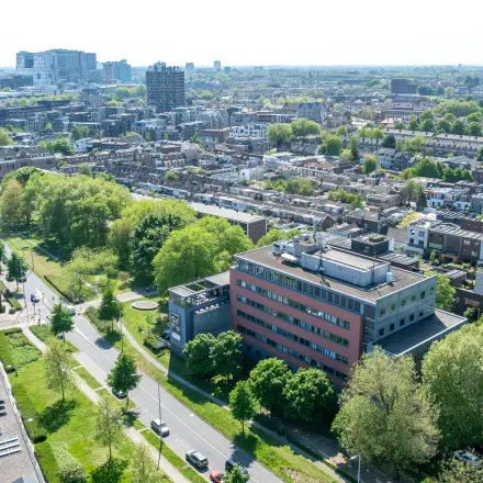 Luchtfoto van een kantoorpand op Goeman Borgesiuslaan 77 in Utrecht Noord, omgeven door veel groen met een duidelijke stedelijke omgeving.