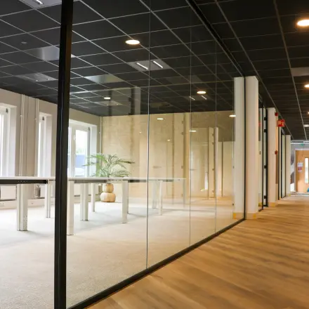 Kantoorruimte huren aan Vijzelmolenlaan 9 in Woerden met glazen wanden en een modern interieur, ideaal voor werkplekken.