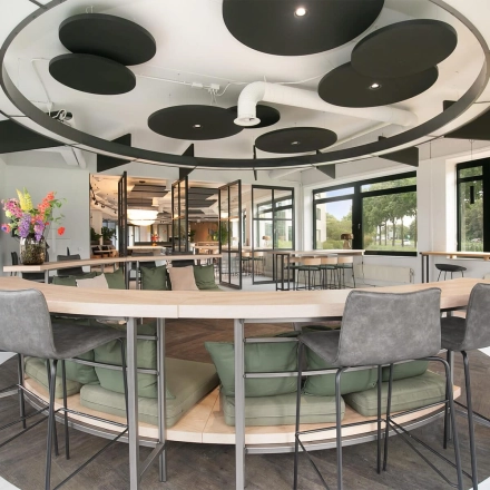 Moderne kantoorruimte met stijlvolle inrichting en groene accenten in Zwolle, gelegen aan Hanzelaan 351-361, perfect om te huren voor een inspirerende werkomgeving.