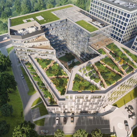 Widok z lotu ptaka na nowoczesny budynek biurowy przy Tischnera 8 w Kraków Podgórze z zielonymi tarasami i przestronnym otwartym planem.