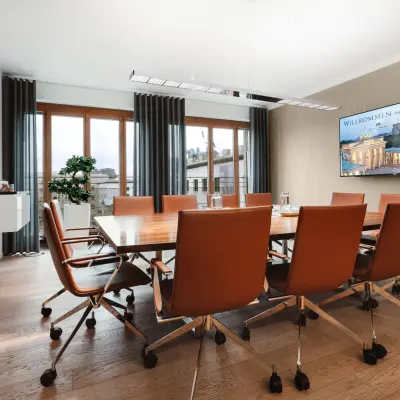 Eleganter Besprechungsraum mit Holztisch und modernen Stühlen, ideal, um in Berlin Mitte am Pariser Platz 6a Bürofläche zu mieten.