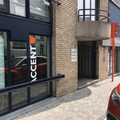 Exterior view of an office building located at Keizersplein 24, Aalst België, featuring signage and a street view.