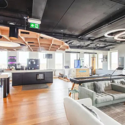 Modern furnished office space with open plan layout, featuring a lounge area and kitchen facilities, ideal for office space rental at Landdrostdreef 124, Almere Stad.