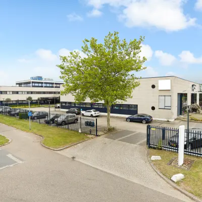 Exterior view of office buildings at Markerkant 1310, Almere Stad, showcasing ample parking and greenery, ideal for office space rental opportunities.