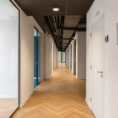 Bright corridor at Veluwezoom 15 in Almere Stad offering access to various office spaces available for rent.