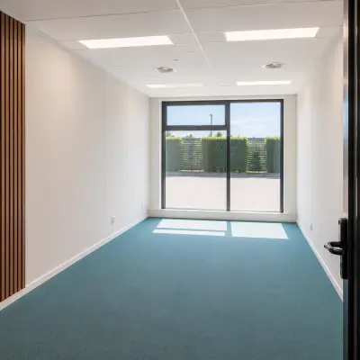 Bright office space rental at Veluwezoom 15, Almere Stad with large window and vibrant carpet.