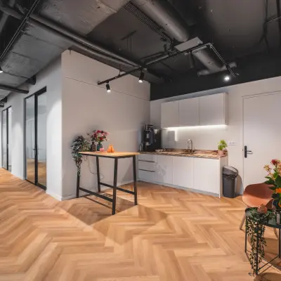 Contemporary office space rental at Veluwezoom 15, Almere Stad, featuring a furnished hallway with a kitchenette area and modern design elements.