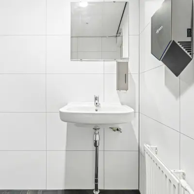 Clean restroom with a modern sink and mirror at Maanlander 43, Amersfoort Calveen.