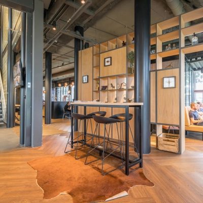 Stylish office space at Maanlander 47, Amersfoort Calveen, featuring modern furnishings and people collaborating at tables, ideal for office space rental.