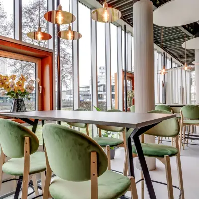 Bright Amersfoort Calveen office interior at Maanlander 47, featuring a stylish, furnished open floorplan with large windows and modern lighting, ideal for office space rental.