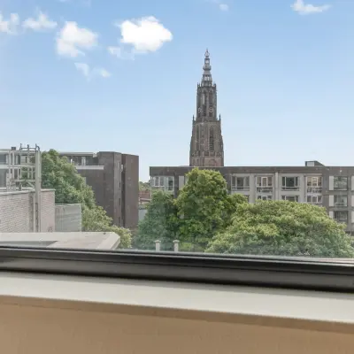 View from a window at an office space rental in Amersfoort Centrum, showcasing cityscape and greenery.