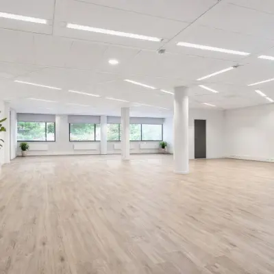 Spacious, unfurnished office space for rent at Asch van Wijckstraat 2-4 in Amersfoort Centrum, featuring large windows and wooden flooring.