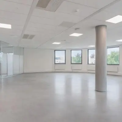 Spacious office space available for rent in Amersfoort Centrum, featuring large windows and an open layout, ideal for setting up workstations or meeting areas.