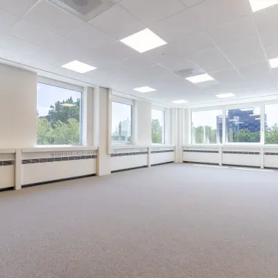 Unfurnished, well-lit office space at De Gondel 1, Amstelveen, showcasing large windows with a view, available for rent.
