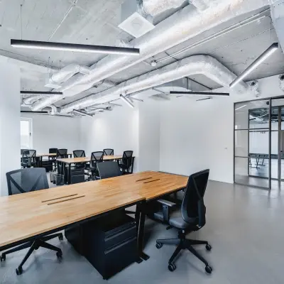 Spacious office space for rent at H.J.E. Wenckebachweg 90-108, showcasing modern interiors with industrial-style ceilings and sleek work desks, perfect for collaborative work in Amsterdam Amstel Business Park.