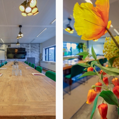 Spacious and well-lit conference room at Prins Bernhardplein 200, Amsterdam Amstel, perfect for rent office space, featuring a large wooden table surrounded by comfortable chairs and modern decor.