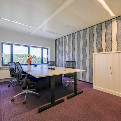 Furnished office space for rent at Prins Bernhardplein 200, Amsterdam Amstel, featuring a table, chairs, and a view of the outdoors.