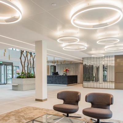 Modern office space for rent at Walborg 2A, Amsterdam Buitenveldert, featuring stylish lighting and comfortable seating in a spacious interior.
