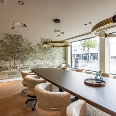 Conference room at Zwaansvliet 1, Amsterdam Buitenveldert, featuring a long table, modern lighting, and large windows. Ideal for office space rental.
