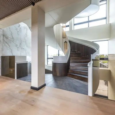 Interior view of Zwaansvliet 1 in Amsterdam Buitenveldert, featuring a stylishly designed spiral staircase in a modern office space.