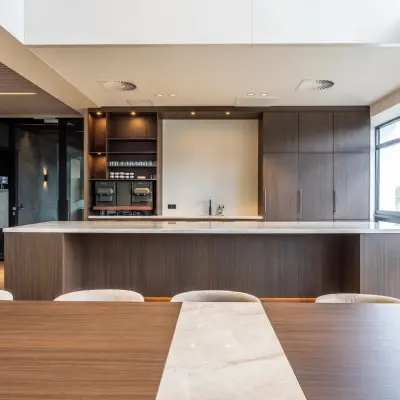 Furnished office space available for rent at Zwaansvliet 1 in Amsterdam Buitenveldert, featuring a modern interior with wooden finishes and ample natural light through large windows.