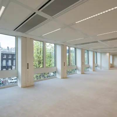Spacious office with large windows at Herengracht 459-469, Amsterdam Canal Belt. Ideal for office space rental, featuring ample natural light and modern design.