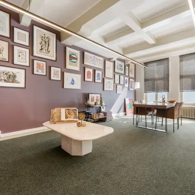 Charming office space in Amsterdam Canal Belt with stylish wall art and modern furnishings, perfect for those seeking office space rental in a prime location.