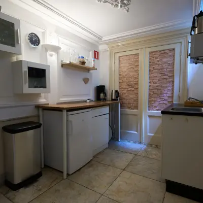 Compact pantry area in office space with countertops, kettle, and storage cabinets, located in Amsterdam Canal Belt at Keizersgracht 391A.