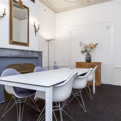 Furnished office to rent at Keizersgracht 62-64 in Amsterdam Canal Belt, featuring a sleek table and modern chairs, ideal for hosting meetings.
