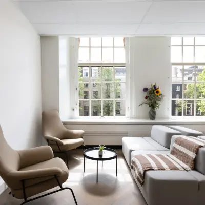 Bright and inviting office space for rent in Amsterdam Center with modern furnishings and large windows overlooking the cityscape.