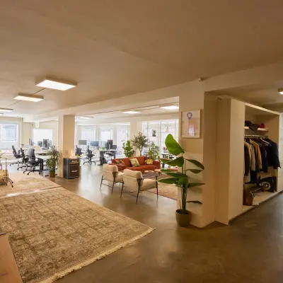 Spacious office interior at Kleine Gartmanplantsoen 21 in Amsterdam Center with modern furnishings, plants, and natural light, ideal for office space rental.