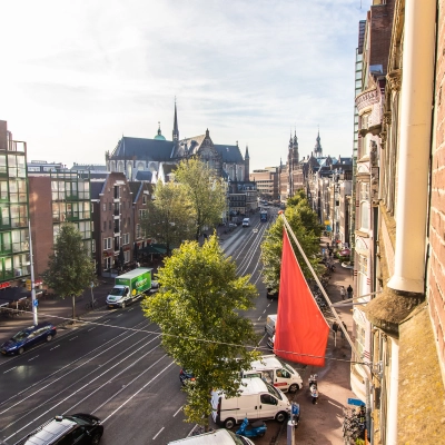 View of Nieuwezijds Voorburgwal in Amsterdam Center, featuring nearby office space rental opportunities.