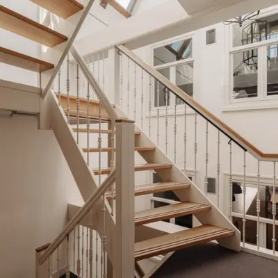 Interior view of a well-lit staircase at Prins Hendrikkade 14, Amsterdam Center, ideal for office space rental.
