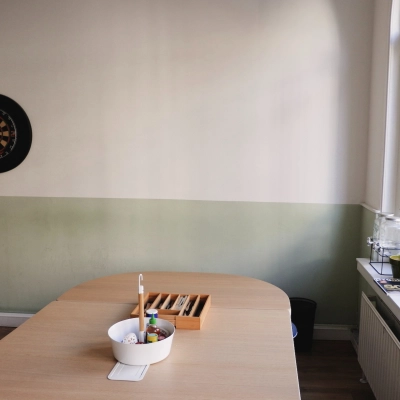 Office space rental in Raadhuisstraat 15, Amsterdam Center featuring a table with office supplies and a dartboard on the wall.