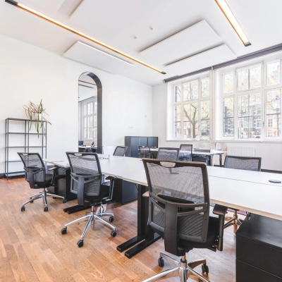 Spacious office space at Raamplein 1, Amsterdam Center, featuring sleek desks and chairs in a bright, modern setting, perfect for office space rental.