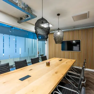 Contemporary office with wooden table and ergonomic chairs, ideal for office space rental at Rapenburgerstraat 173, Amsterdam Center.