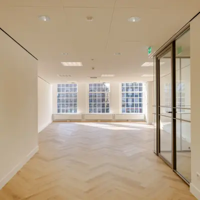 Spacious office space rental at Rokin 117, 117 in Amsterdam Center with large windows and wooden floors. Ideal for businesses seeking an office to rent.