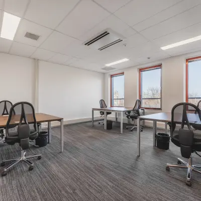Bright office space rental at Daalwijkdreef 47, Amsterdam Duivendrecht, featuring multiple desks and chairs with natural light streaming in.