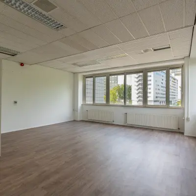 Bright office space with large windows offering natural light, located at James Wattstraat 71 in Amsterdam East, suitable for office space rental.
