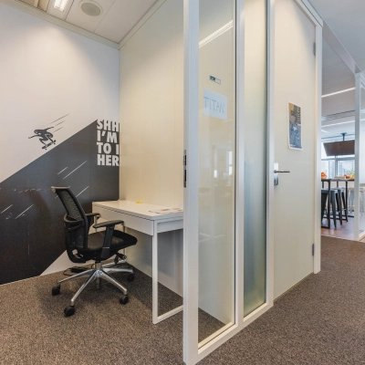Office at Piet Heinkade 95B, Amsterdam East featuring a meeting cubicle and a coworking area. Ideal for those seeking office space rental. Spacious design with modern furnishings.