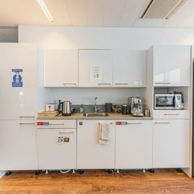 Modern kitchenette in office space for rent featuring appliances and a clean design at Piet Heinkade 95B, Amsterdam East.