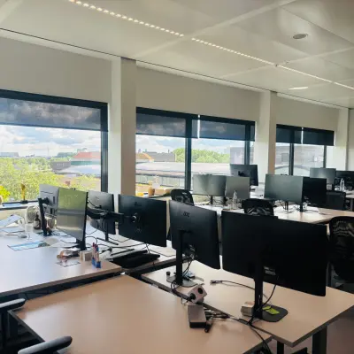 Bright office space for rent with multiple workstations, large windows, and views of Amsterdam East at Science Park 301.