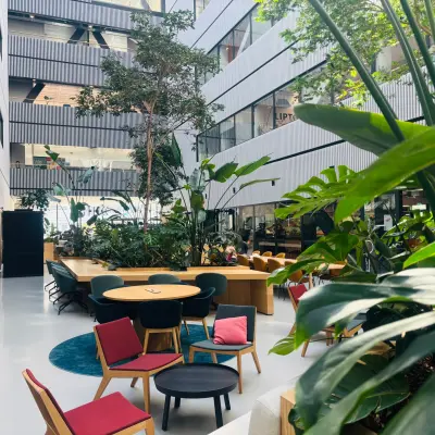 Modern office interior at Science Park 301, Amsterdam East, featuring lush greenery and stylish seating perfect for an inviting office space rental or office to rent.
