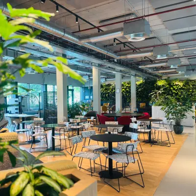 Modern office space at Science Park 301 in Amsterdam East featuring open workspaces with contemporary furniture, lush greenery, and natural lighting. Ideal for office space rental or finding an office to rent.