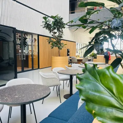 Modern office space at Science Park 301 in Amsterdam East, featuring stylish furniture, greenery, and a glass booth, ideal for rent office space or office space rental.