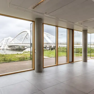 Bright office space in Amsterdam IJburg with large windows offering scenic views of the surrounding area, perfect for businesses seeking office space rental.