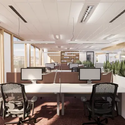 Bright Amsterdam IJburg office space with workstations and natural light. Ideal for office space rental. Features modern desks, chairs, and plants, offering a professional atmosphere.