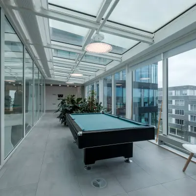 Bright office space with a pool table under a glass ceiling at Pedro de Medinalaan 7, Amsterdam IJburg, available for office space rental.