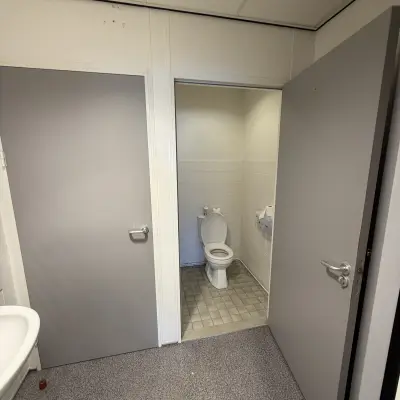 Interior view of a restroom with a toilet and sink, suitable as a part of office space rental at Buikslotermeerplein 430, Amsterdam North.